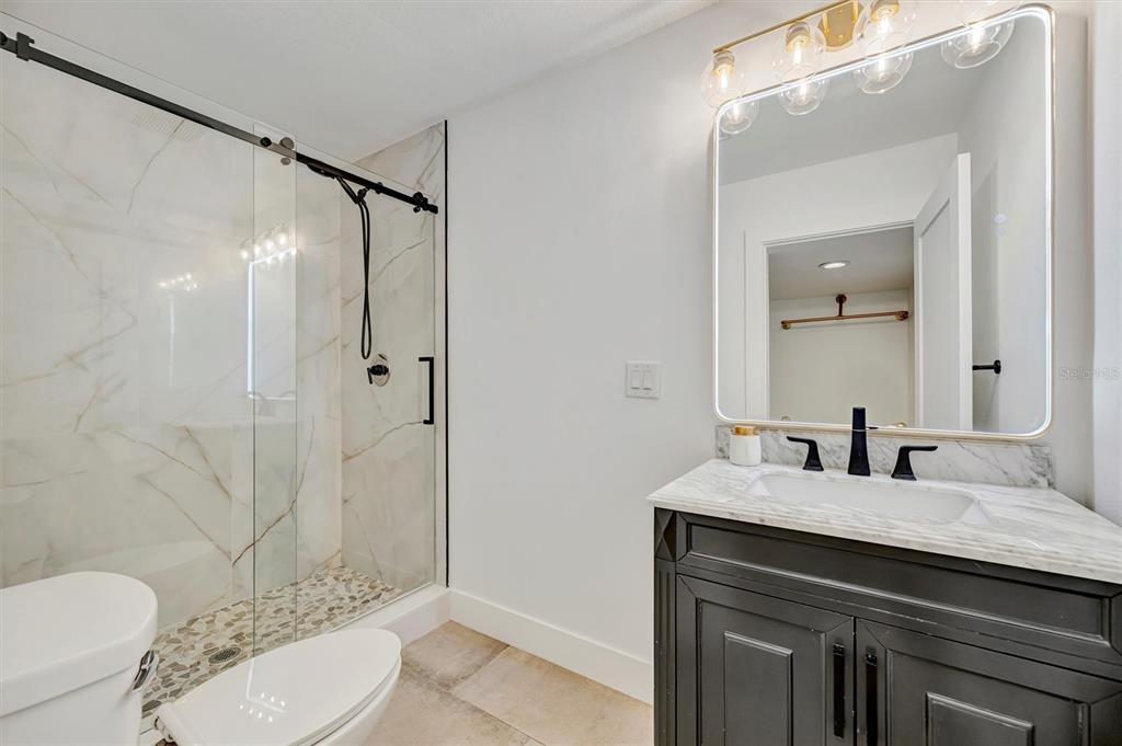 403 Longbow Trail Osprey, FL 34229 - Photo 75 of 99 a bathroom with a sink vanity mirror and toilet