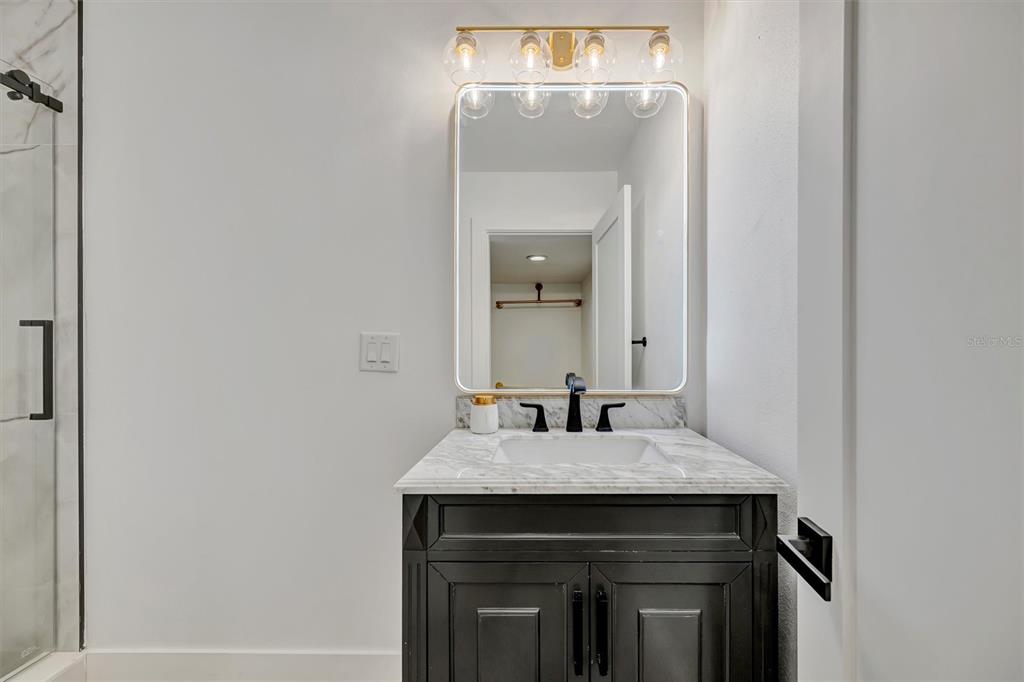 403 Longbow Trail Osprey, FL 34229 - Photo 76 of 99 a bathroom with a sink and a mirror