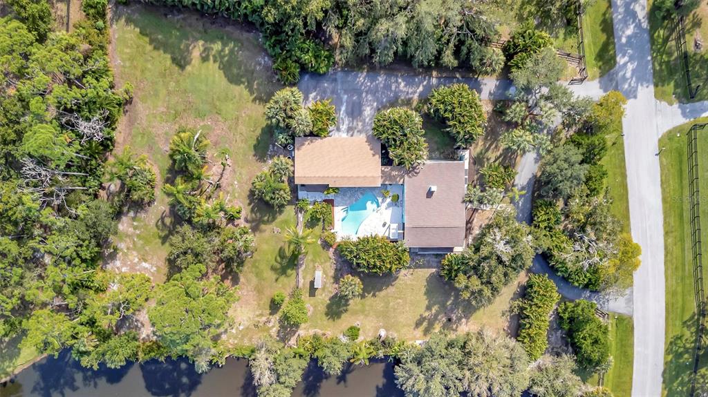 403 Longbow Trail Osprey, FL 34229 - Photo 80 of 99 an aerial view of a house with a yard and garden in back