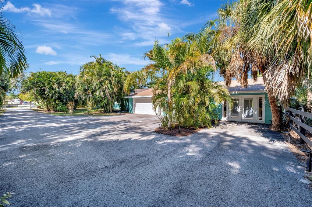 403 Longbow Trail Osprey, FL 34229 - Photo 85 of 99 a view of a house with a tree and plants