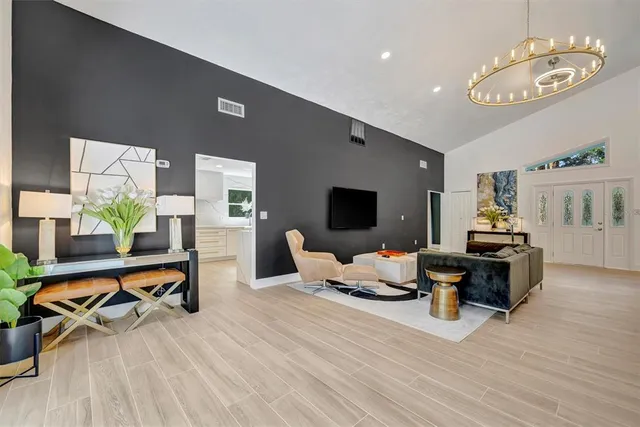 a living room with furniture wooden floor and a flat screen tv