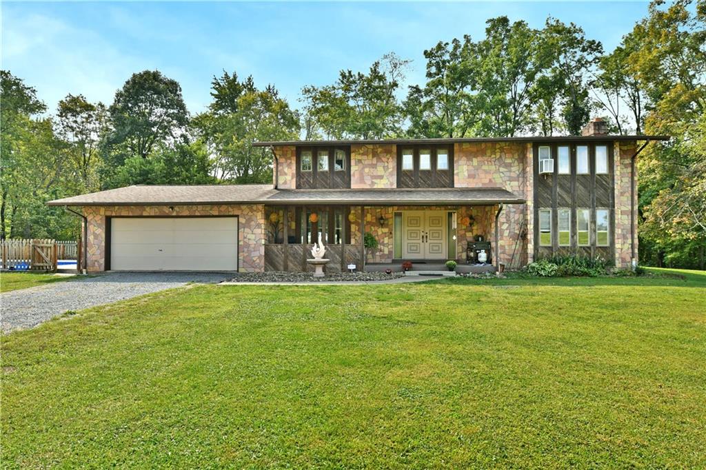 a view of a house with a yard and a garden