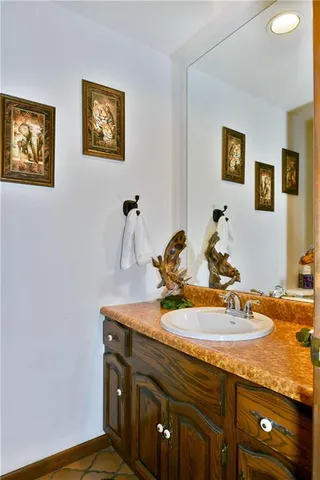 a bathroom with a sink a mirror and vanity