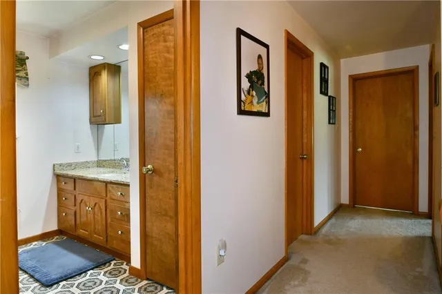 a bathroom with a granite countertop sink a mirror and shower