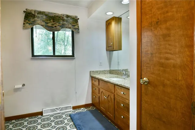 a bathroom with a glass shower door