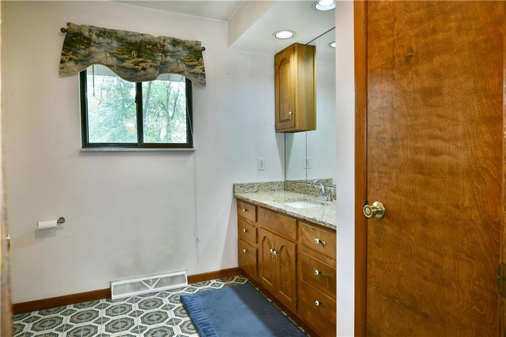108 Davis Lane Freedom, PA 15042 - Photo 33 of 50 a bathroom with a granite countertop sink a mirror and shower