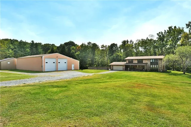 aerial view of a house with pool and a yard