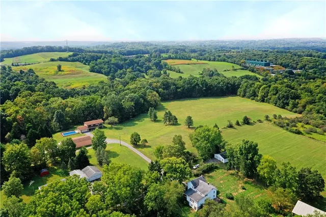 an aerial view of residential houses with outdoor space and street view