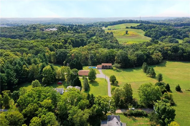 an aerial view of a houses with a yard