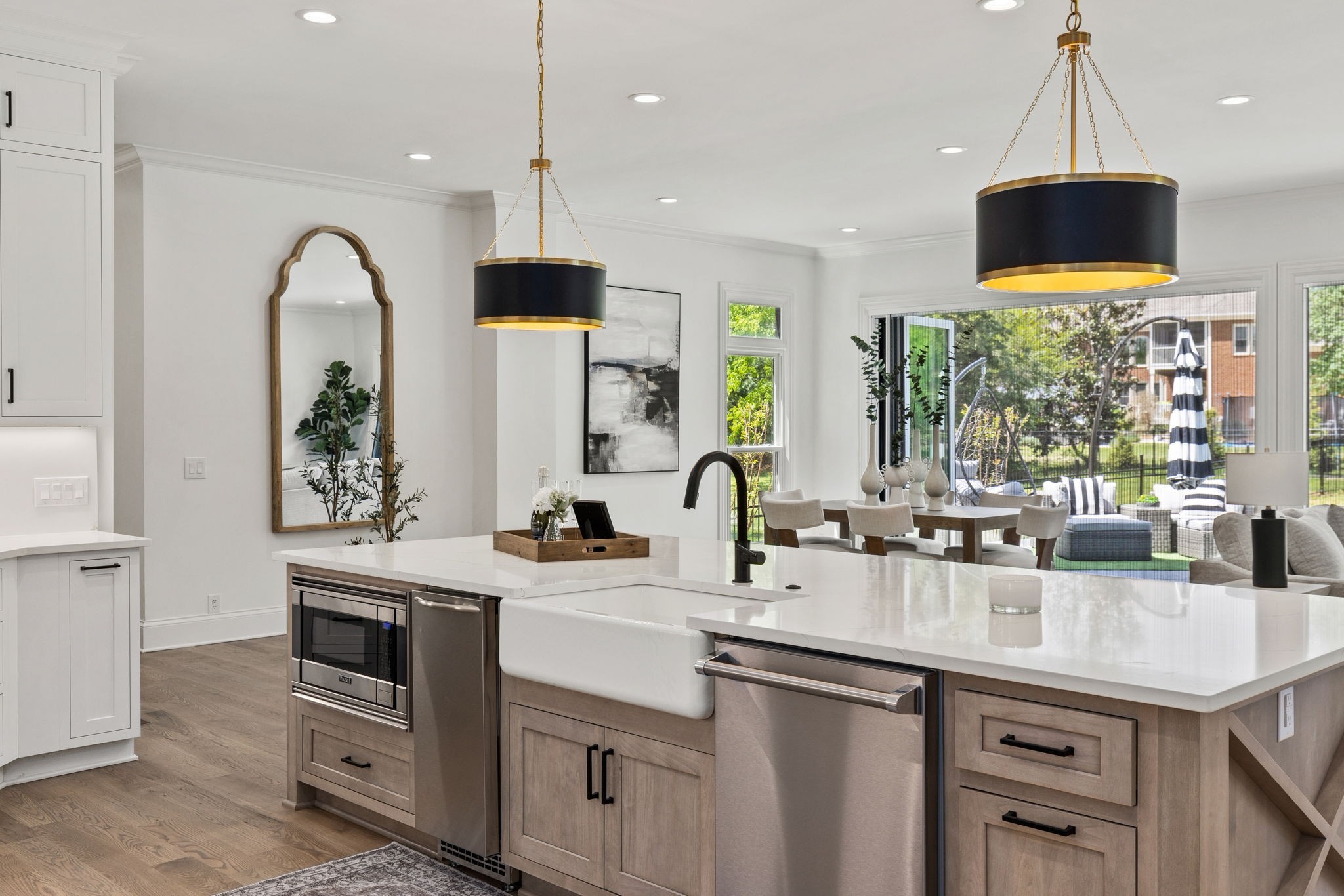 9050 Split Log Road Brentwood, TN 37027 - Photo 13 of 69 a kitchen with stainless steel appliances granite countertop a sink a stove and a dining table with wooden floor