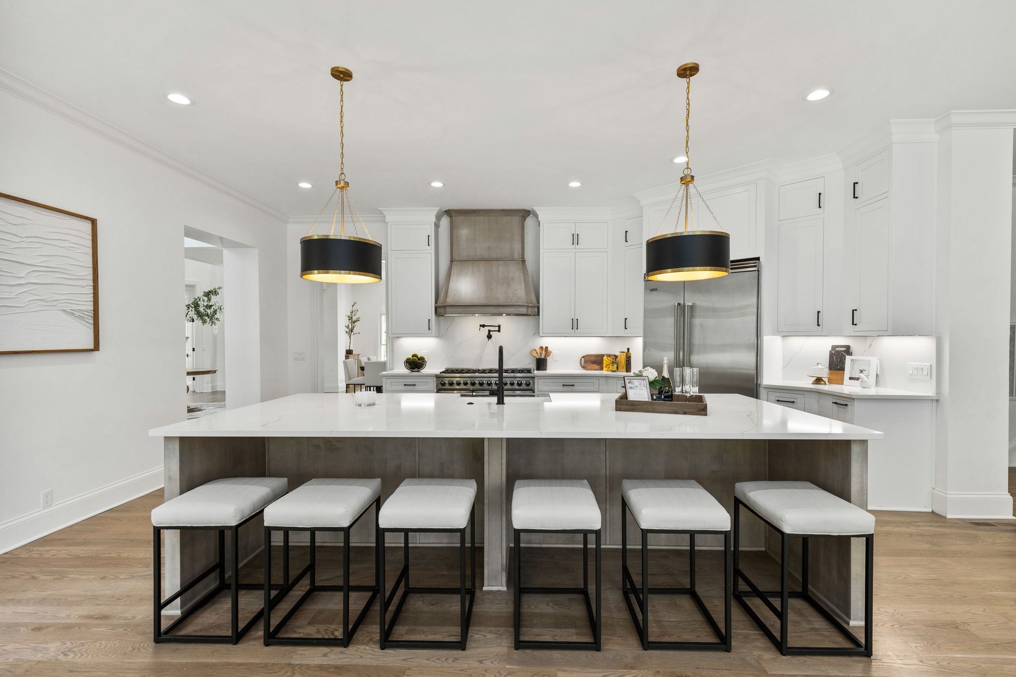 9050 Split Log Road Brentwood, TN 37027 - Photo 16 of 69 a kitchen with stainless steel appliances a dining table chairs and white cabinets