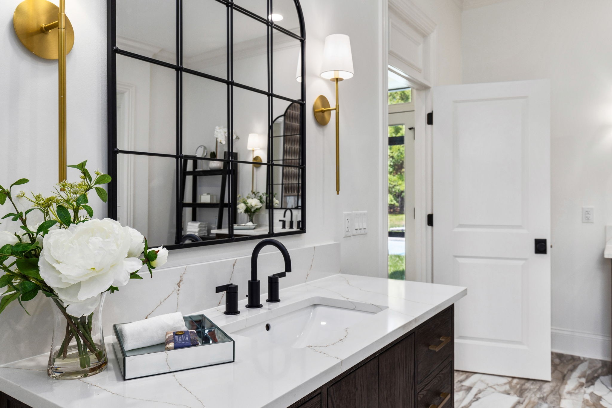 9050 Split Log Road Brentwood, TN 37027 - Photo 32 of 69 a bathroom with a sink and mirror with bathtub