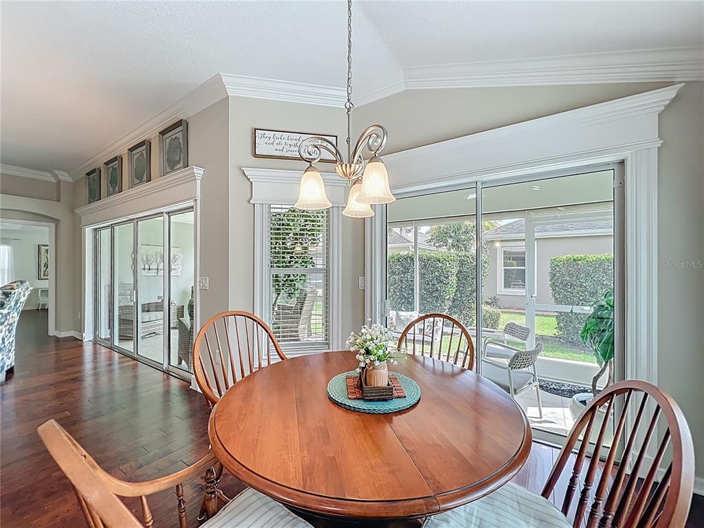 2875 Rain Lily Loop The Villages, FL 32163 - Photo 14 of 36 a view of a dining room with furniture window and wooden floor