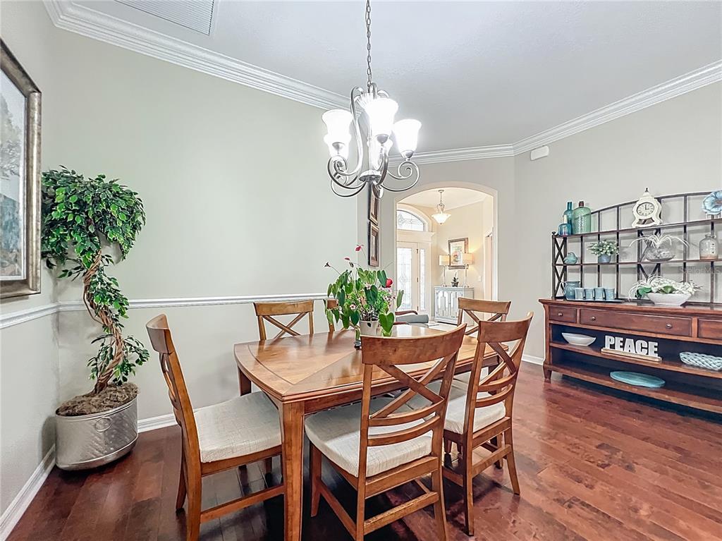 2875 Rain Lily Loop The Villages, FL 32163 - Photo 15 of 36 a dining room with furniture potted plants and wooden floor