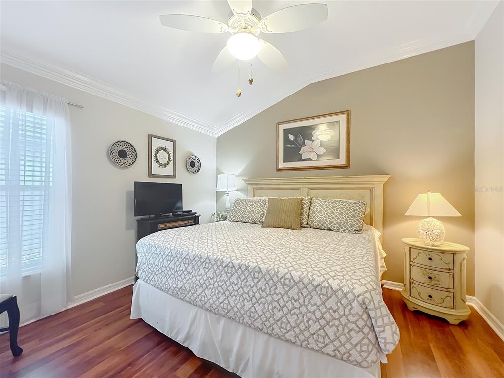 2875 Rain Lily Loop The Villages, FL 32163 - Photo 19 of 36 a bedroom with a bed and wooden floor