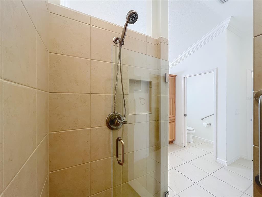 2875 Rain Lily Loop The Villages, FL 32163 - Photo 25 of 36 a bathroom with a shower and a toilet