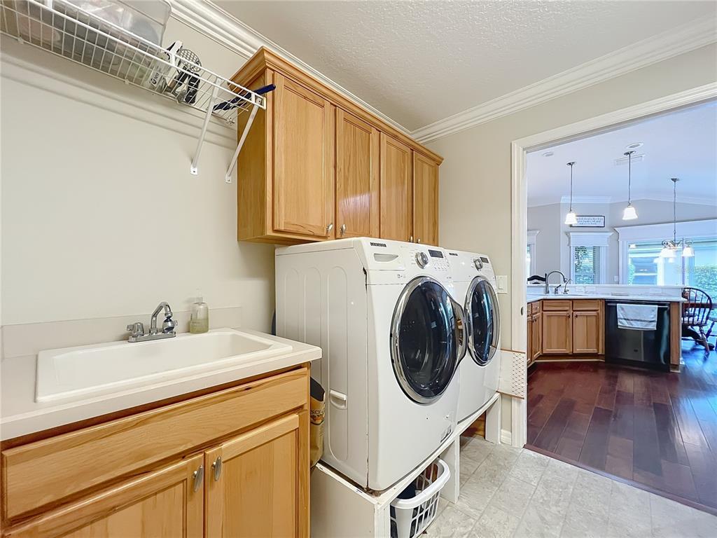2875 Rain Lily Loop The Villages, FL 32163 - Photo 29 of 36 a utility room with dryer and washer