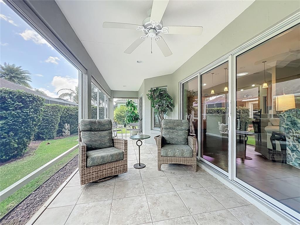 2875 Rain Lily Loop The Villages, FL 32163 - Photo 30 of 36 a living room with furniture and a yard