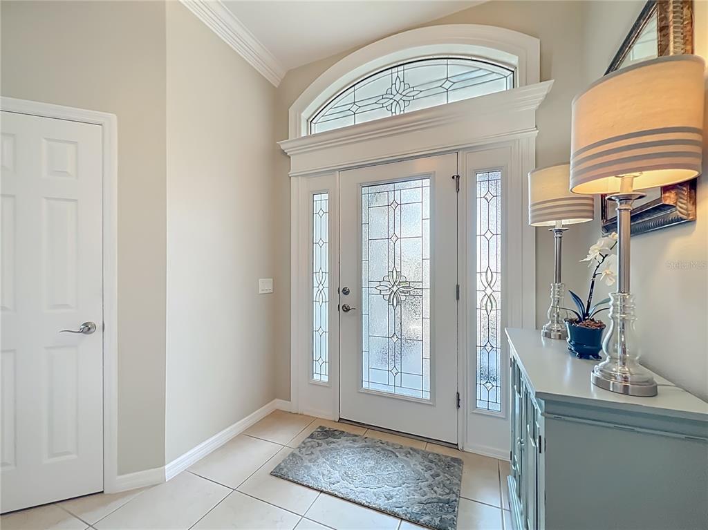 2875 Rain Lily Loop The Villages, FL 32163 - Photo 3 of 36 a view of an entryway with a chandelier