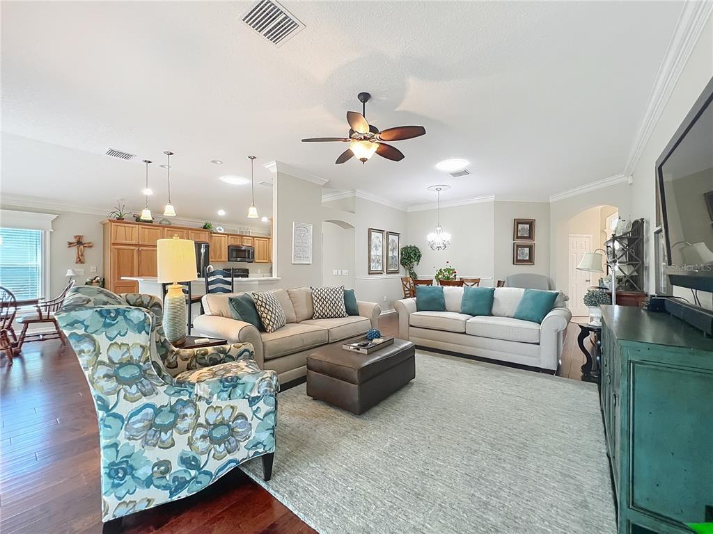 2875 Rain Lily Loop The Villages, FL 32163 - Photo 6 of 36 a living room with furniture and a chandelier