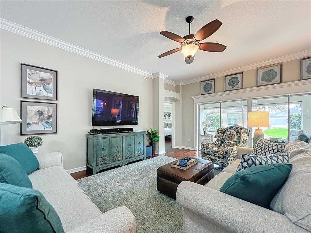 2875 Rain Lily Loop The Villages, FL 32163 - Photo 7 of 36 a living room with furniture and a flat screen tv