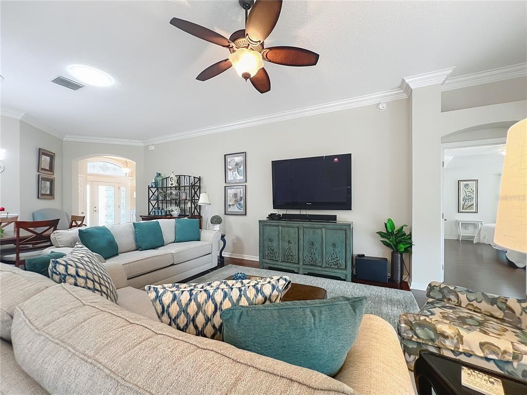 2875 Rain Lily Loop The Villages, FL 32163 - Photo 8 of 36 a living room with furniture and a flat screen tv