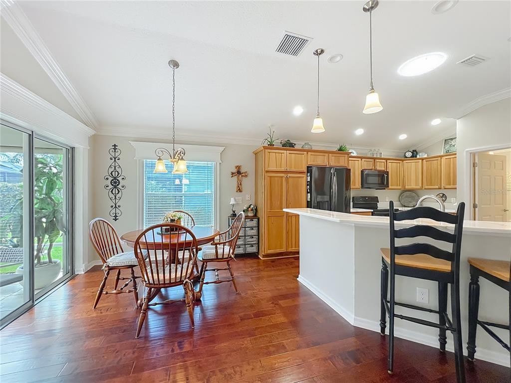 2875 Rain Lily Loop The Villages, FL 32163 - Photo 9 of 36 a dining room with furniture and wooden floor
