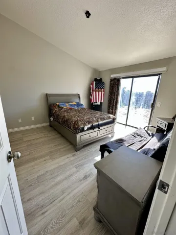 a living room with hard wood floors and a table