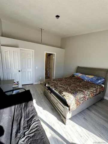 a bedroom with a bed and a dresser