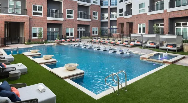 a front view of a house with swimming pool garden and patio