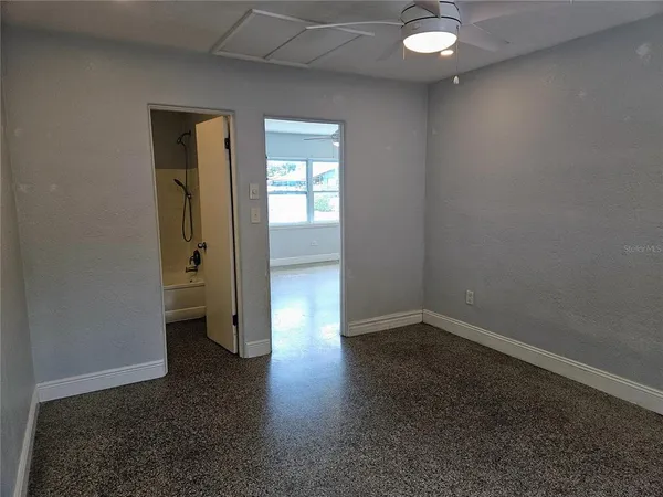 an empty room with wooden floor and a window