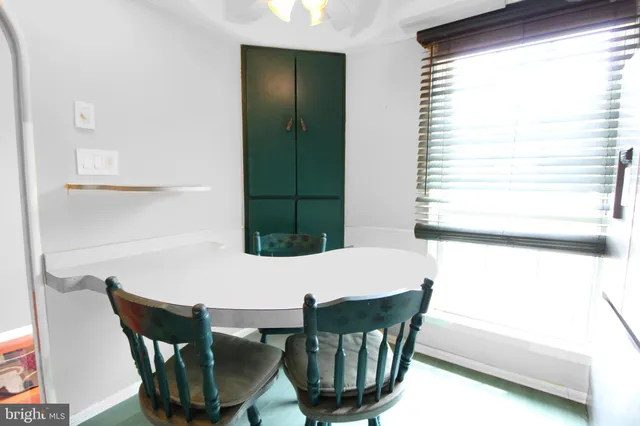 a view of a dining room with furniture and window