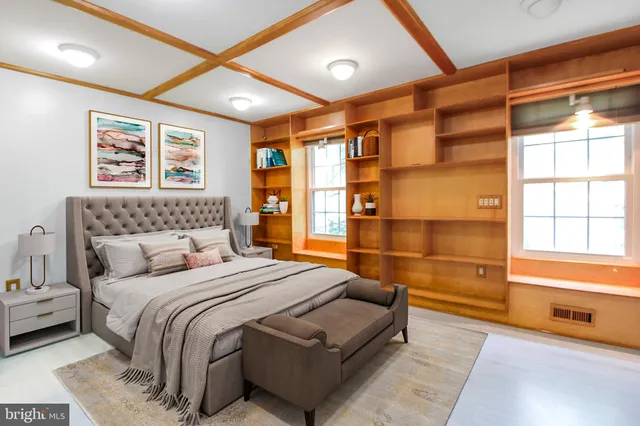 a bedroom with a large bed and a window