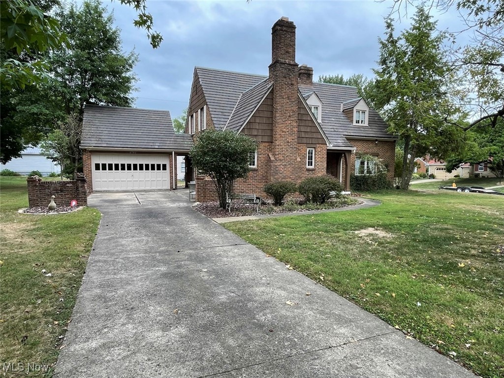 2702 Martin Road Zanesville, OH 43701 - Photo 2 of 34 View of front of house with a garage and a front lawn