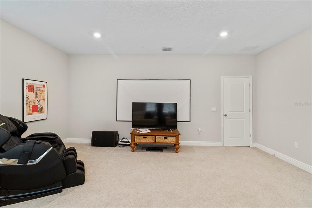 8764 Powder Ridge Trail Windermere, FL 34786 - Photo 31 of 43 a living room with furniture and a flat screen tv