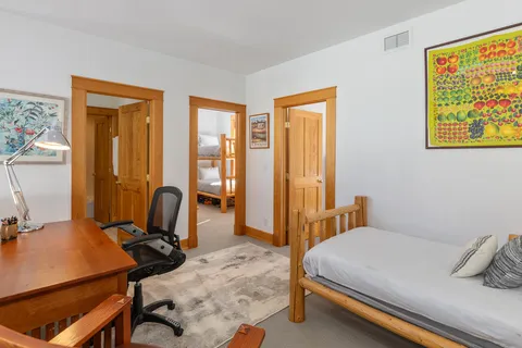 a bedroom with a bed and wooden floor
