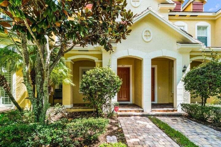 207 Edenberry Avenue Jupiter, FL 33458 - Photo 1 of 16 a front view of a house with garden