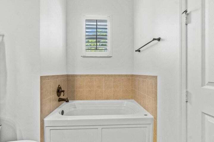 207 Edenberry Avenue Jupiter, FL 33458 - Photo 7 of 16 a bathroom with a bathtub