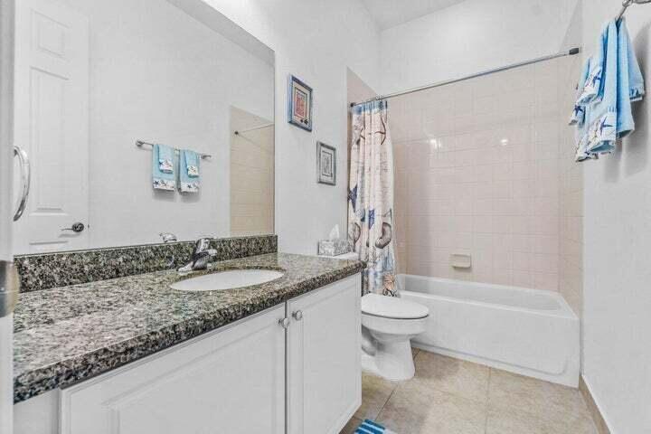207 Edenberry Avenue Jupiter, FL 33458 - Photo 8 of 16 a bathroom with a granite countertop sink a toilet a mirror and shower