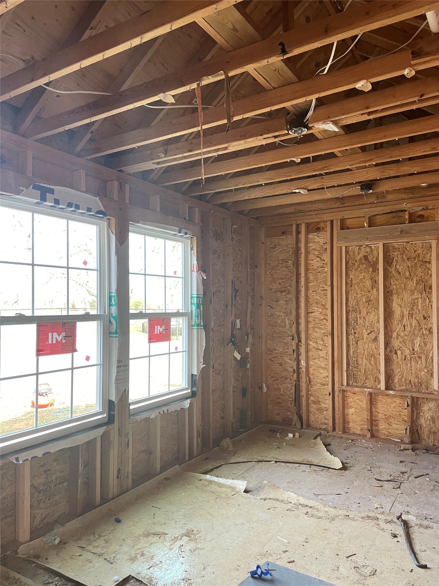 2238 Flash Circle Luling, TX 78648 - Photo 3 of 5 Framed interior space awaiting finishing touches, with bright windows.