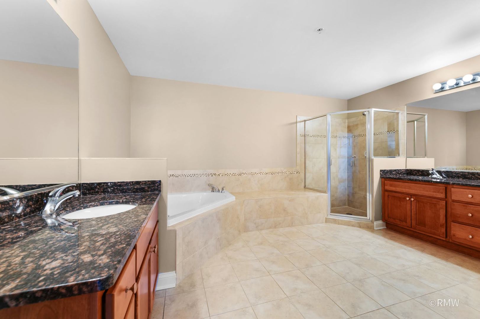 2 Itasca Place, Unit 420 Addison, IL 60143 - Photo 16 of 20 a bathroom with a granite countertop sink and mirror