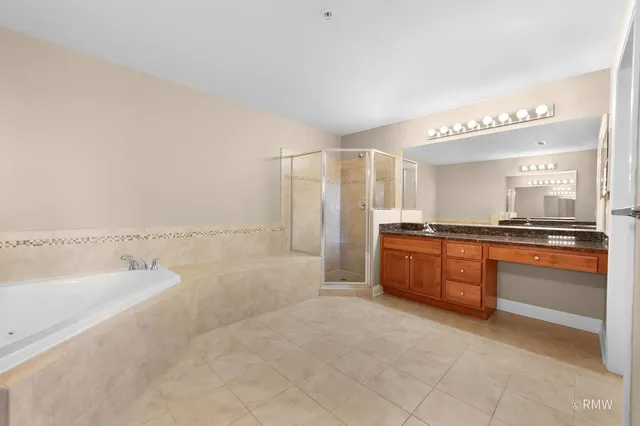 a bathroom with a tub sink and mirror
