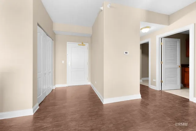 a view of hallway with wooden floor