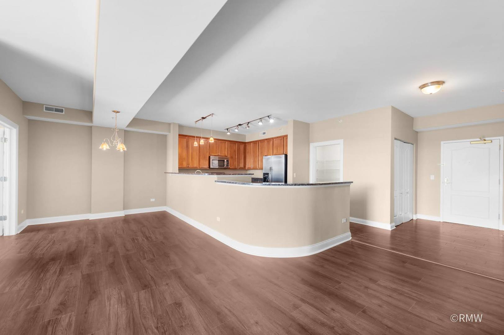 2 Itasca Place, Unit 420 Addison, IL 60143 - Photo 6 of 20 a view of a big room with wooden floor and windows