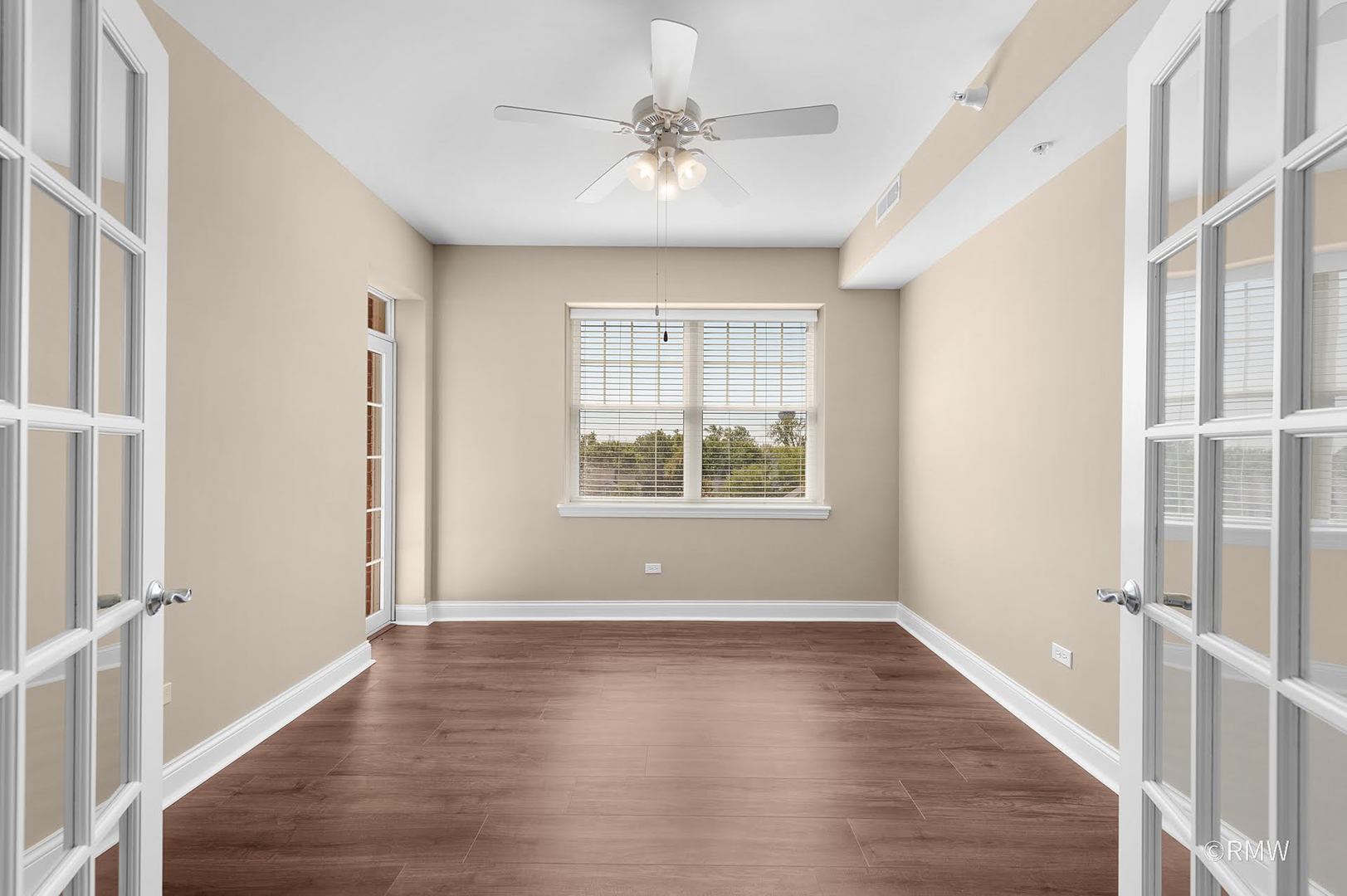 2 Itasca Place, Unit 420 Addison, IL 60143 - Photo 10 of 20 an empty room with wooden floor chandelier and windows
