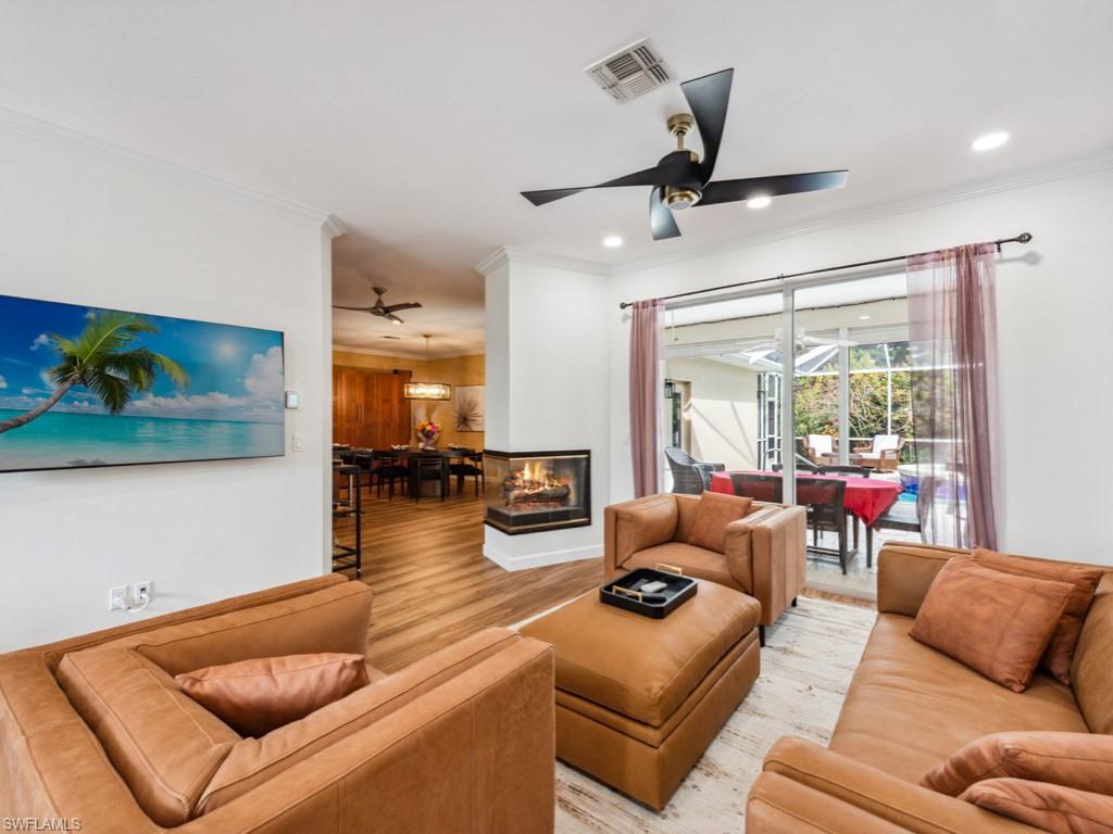 127 Palmetto Dunes Circle Naples, FL 34113 - Photo 11 of 20 a living room with furniture and a large window