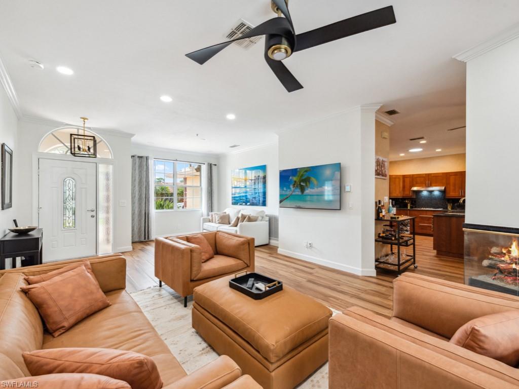 127 Palmetto Dunes Circle Naples, FL 34113 - Photo 12 of 20 a living room with furniture and a flat screen tv