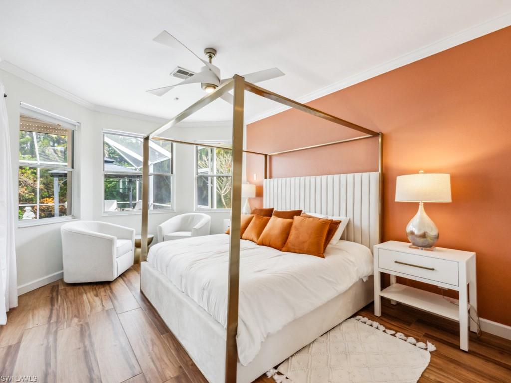 127 Palmetto Dunes Circle Naples, FL 34113 - Photo 14 of 20 a bedroom with a bed wooden floor and window
