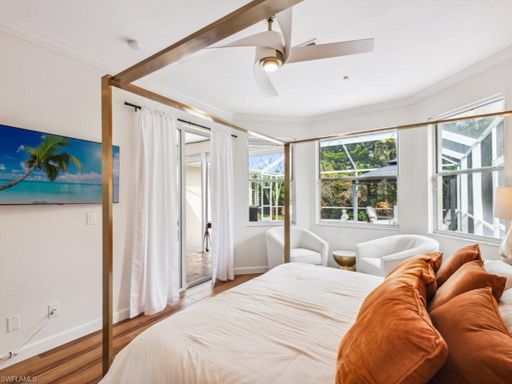 127 Palmetto Dunes Circle Naples, FL 34113 - Photo 15 of 20 a bed sitting in a bedroom next to a window