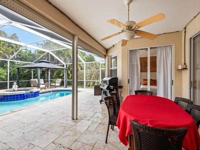 a view of a hall with a dining table and chairs